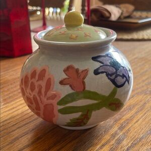 Hand-Painted Floral Ceramic Jar with Green Lid.